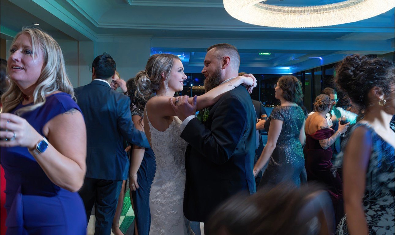 Couple dancing together under blue party lighting